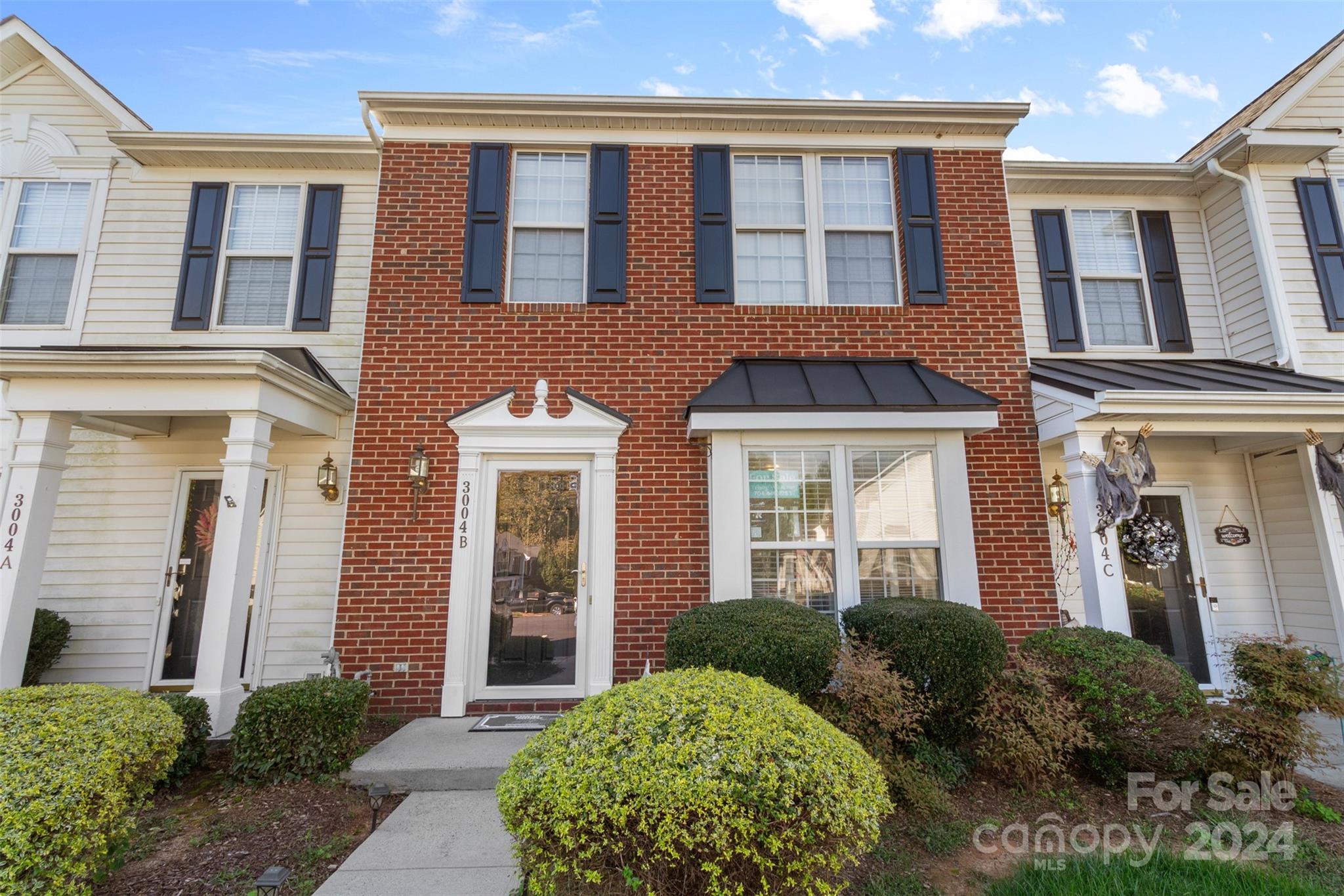 front view of a brick house with a large windows