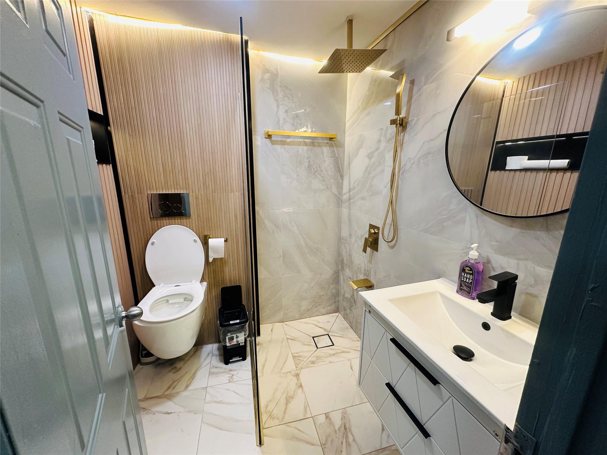 a bathroom with a sink mirror and toilet