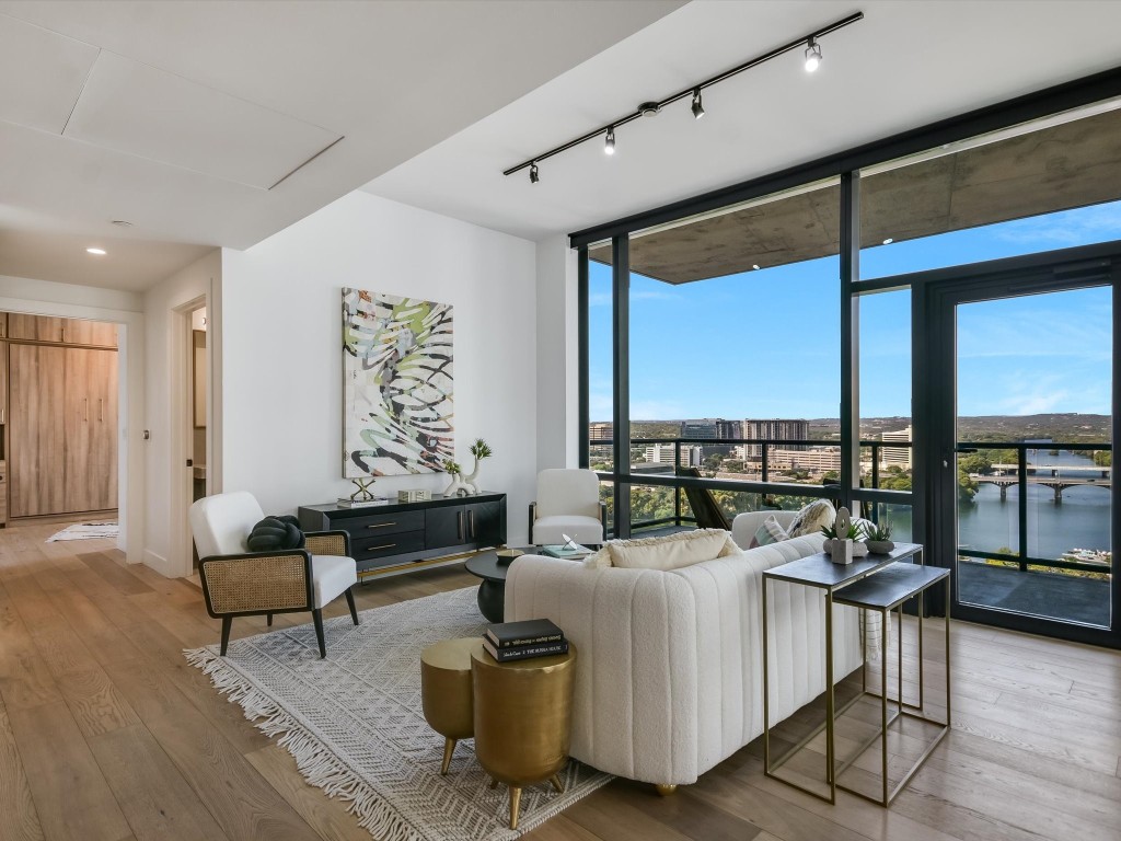 a living room with furniture and floor to ceiling window