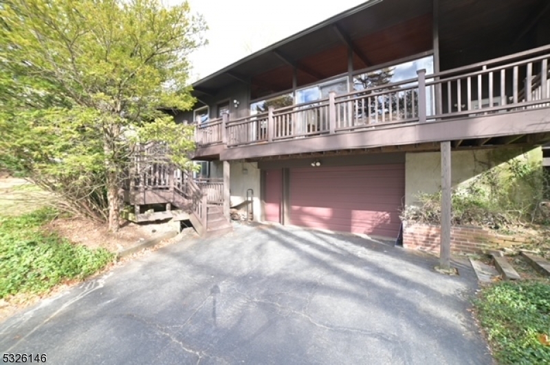 a view of a house with a patio and a yard