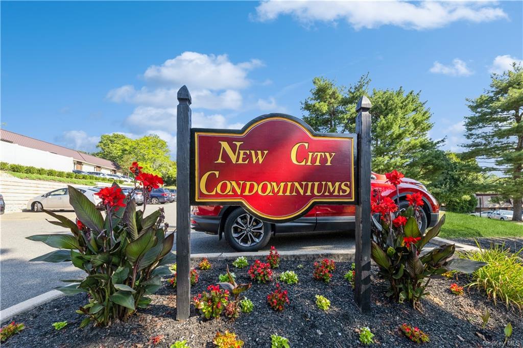 a view of sign board with flower in the background