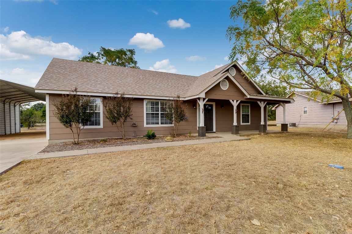 a front view of a house with a garden