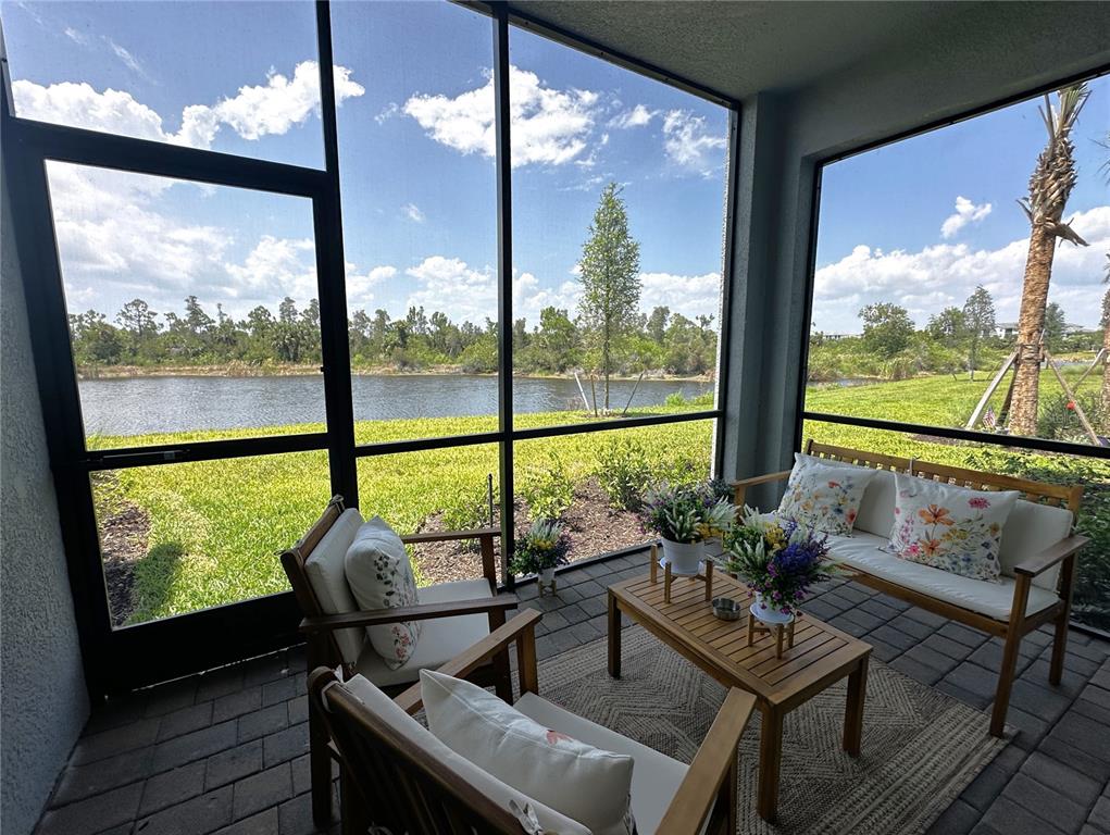 a living room with large windows and a table