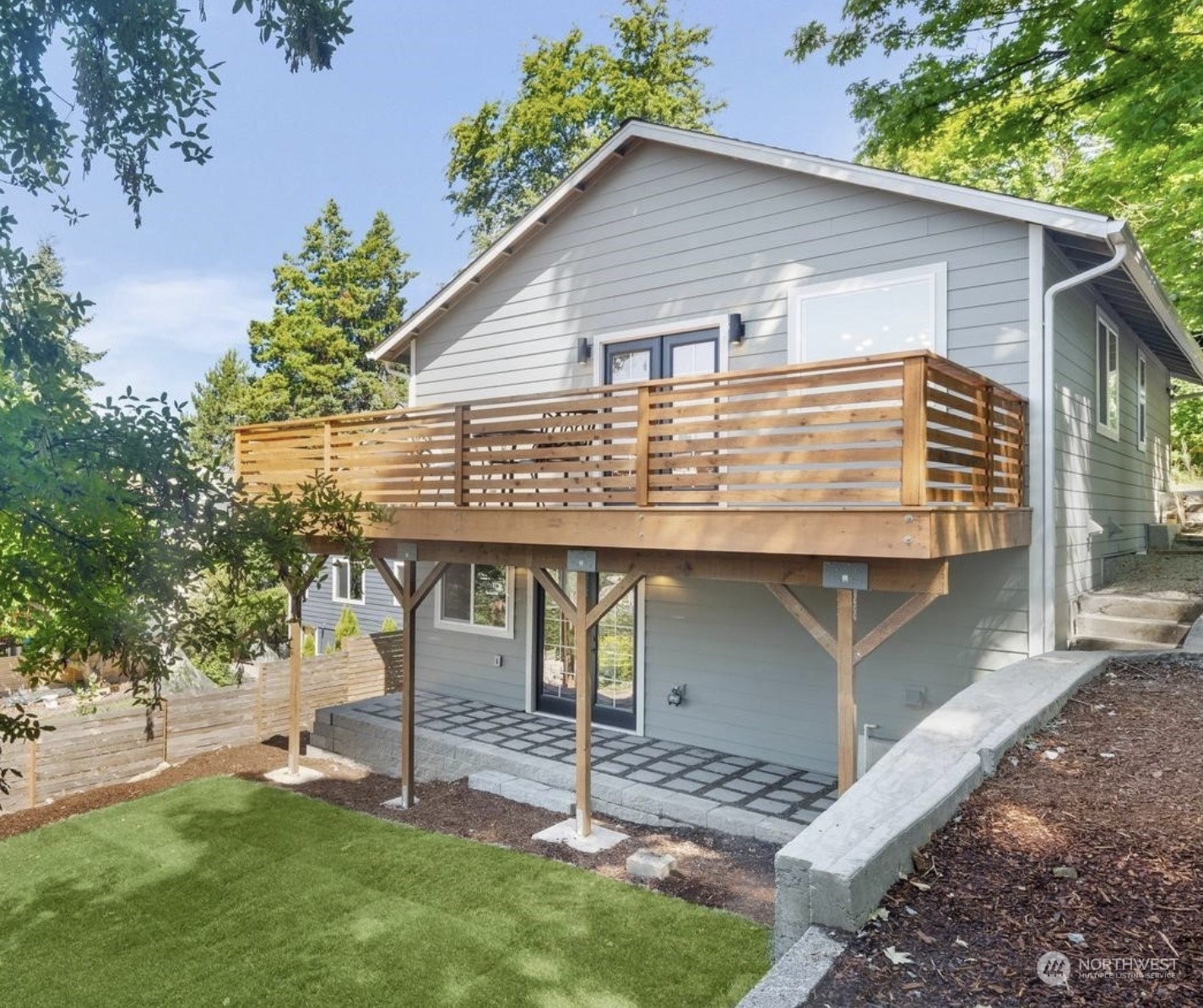 a view of a house with a yard patio and a garden