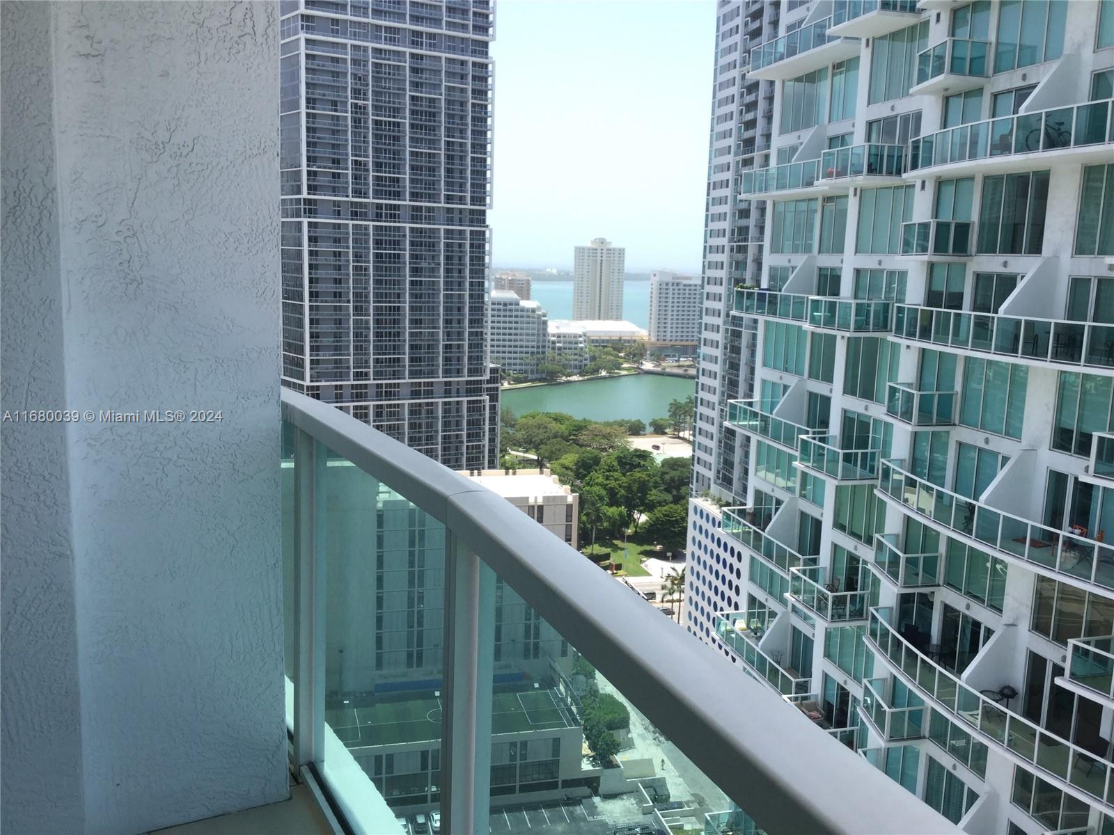 a view of balcony with a couple of cars parked in front of a door