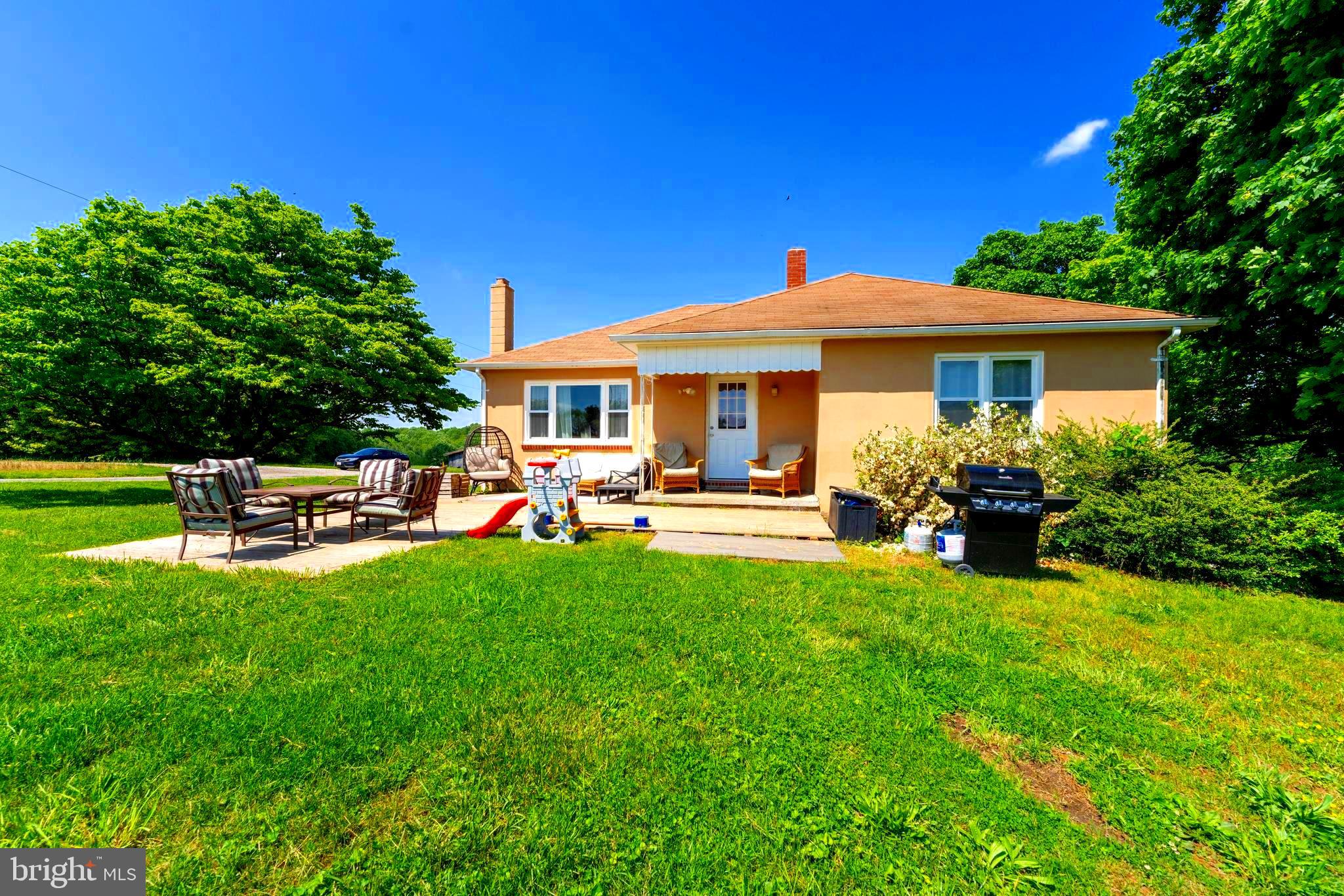 a backyard of a house with table and chairs