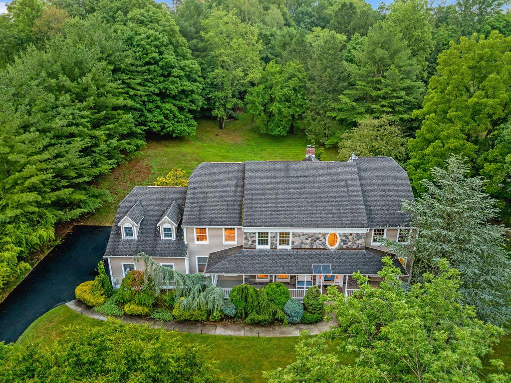 an aerial view of a house with garden space and street view