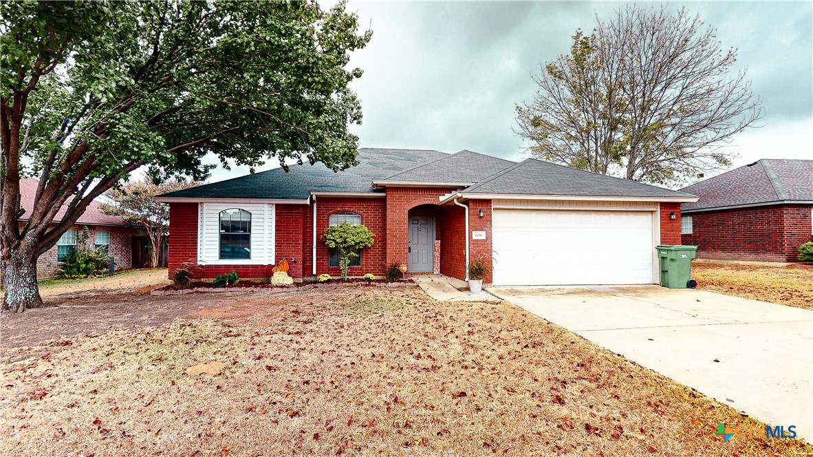 a front view of a house with a garden and patio