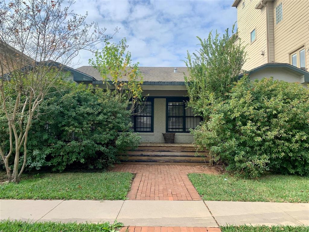 a front view of a house with plants