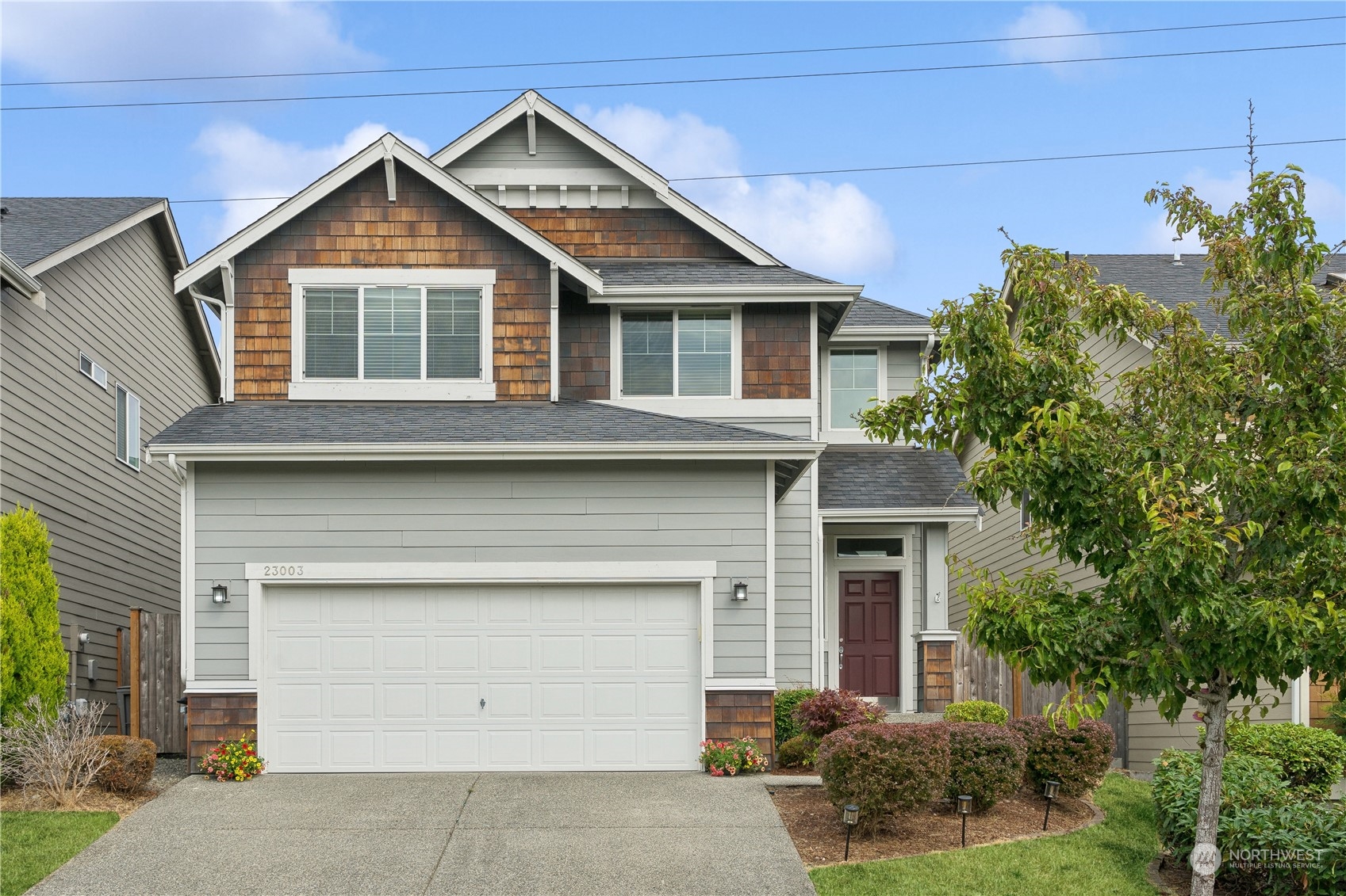 a front view of a house with a yard and garage