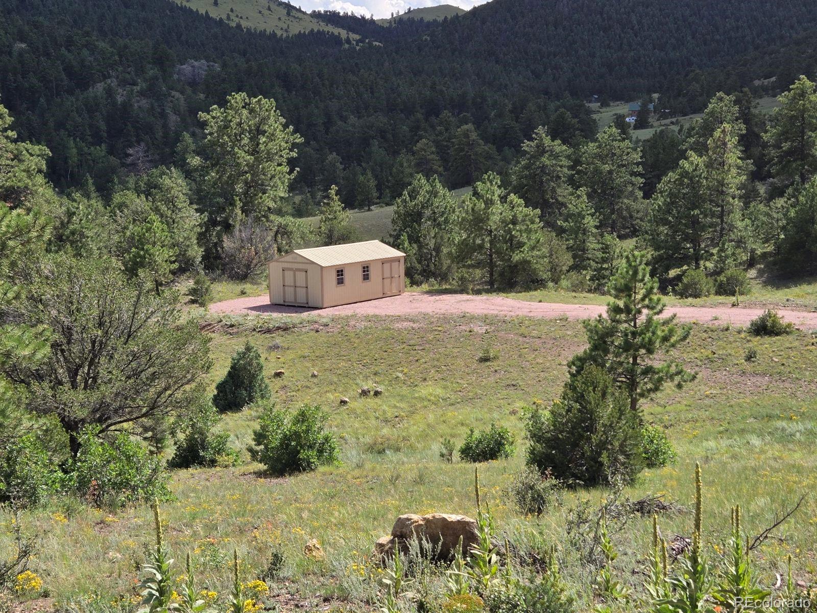 a view of a wooden house with a yard