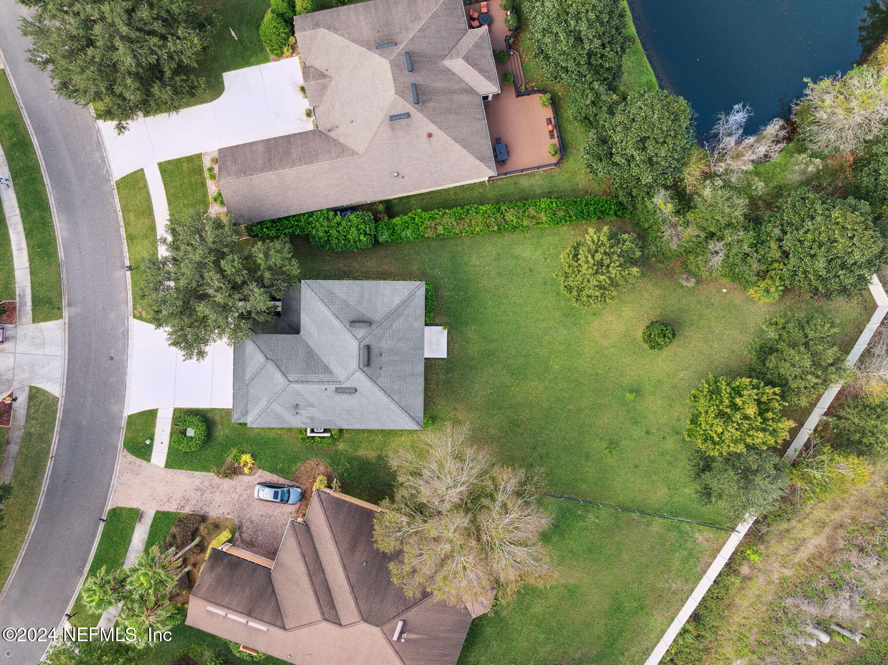 an aerial view of a house with a yard basket ball court and outdoor seating