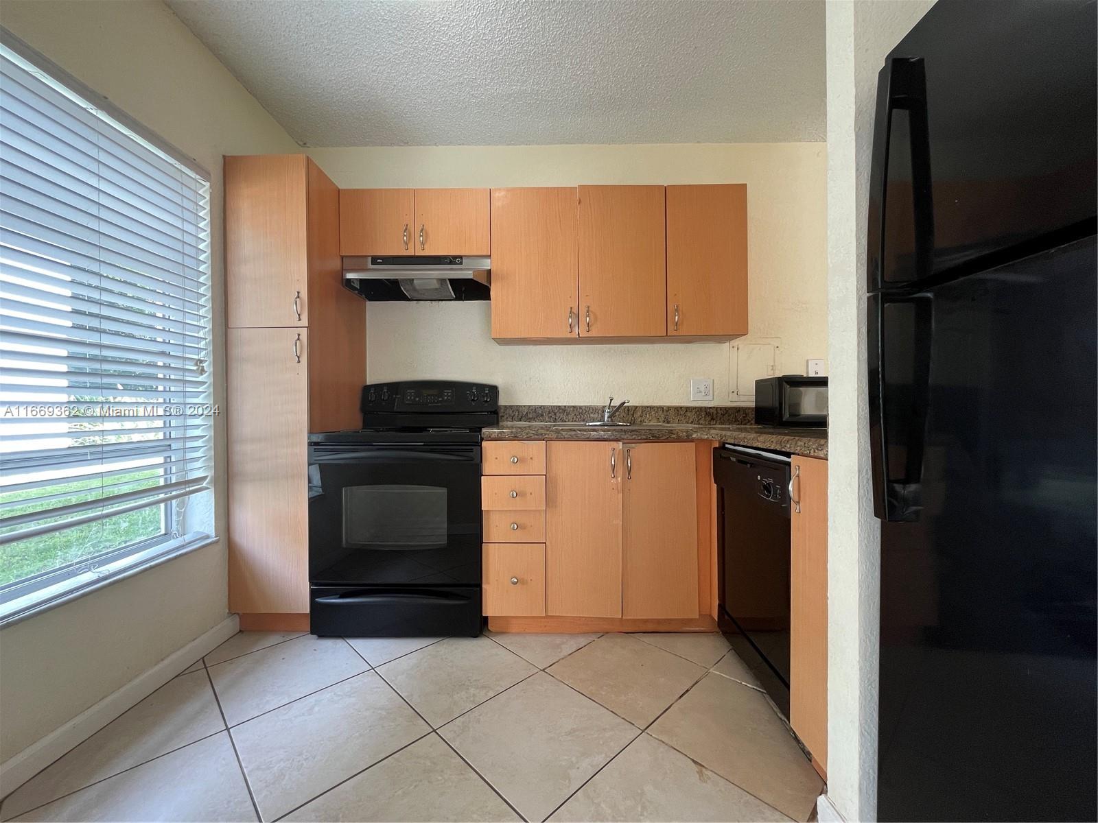 a kitchen with a stove and a refrigerator