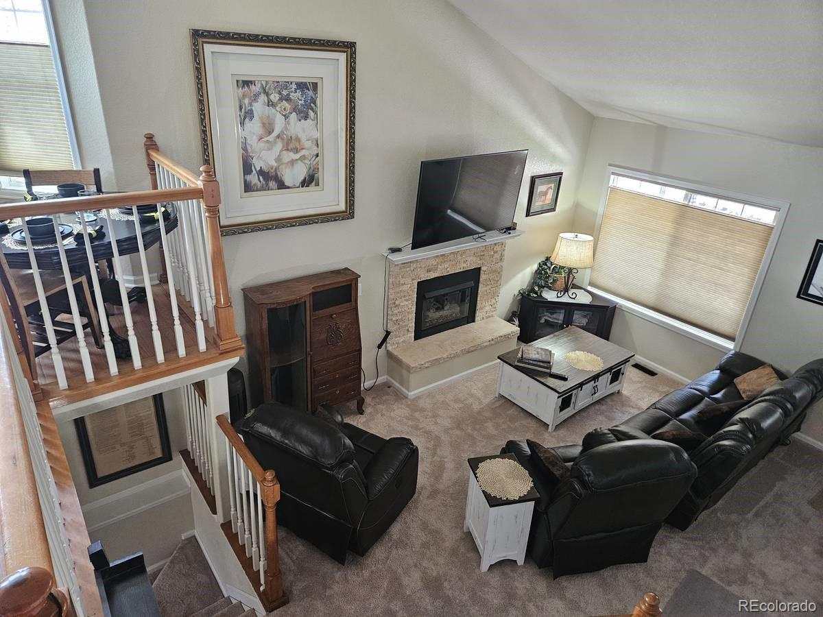 a living room with furniture fireplace and flat screen tv