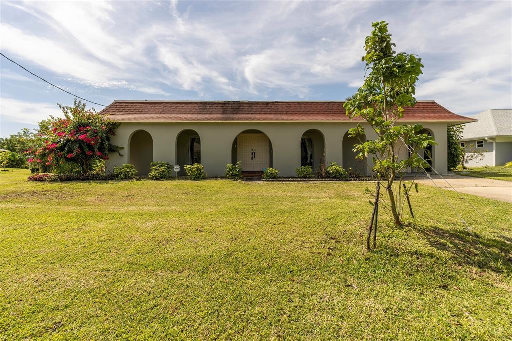 a house view with swimming pool in front of it