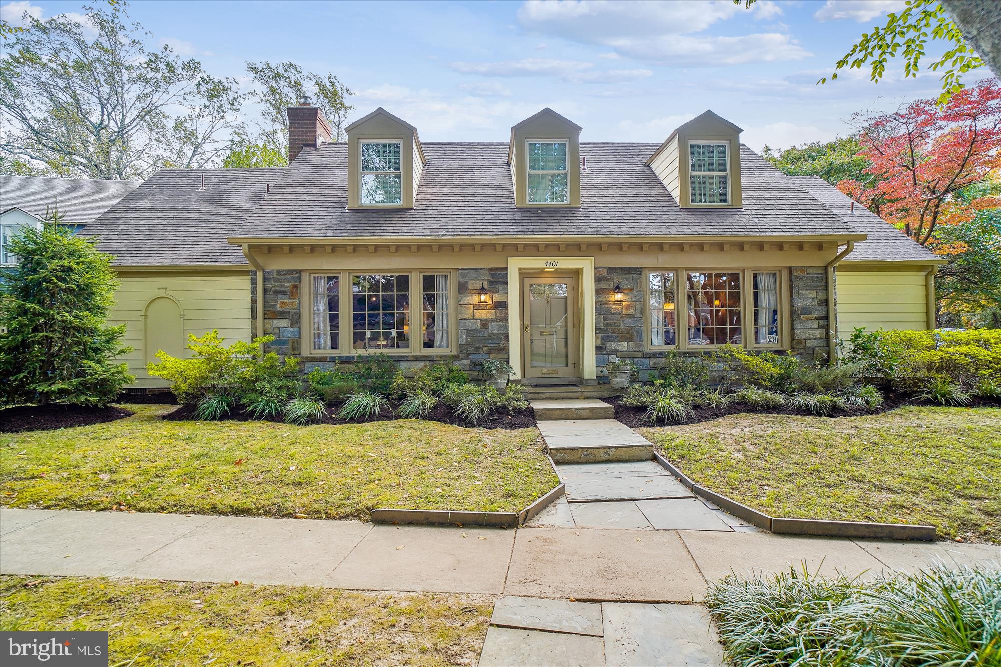 a view of a brick house with a yard