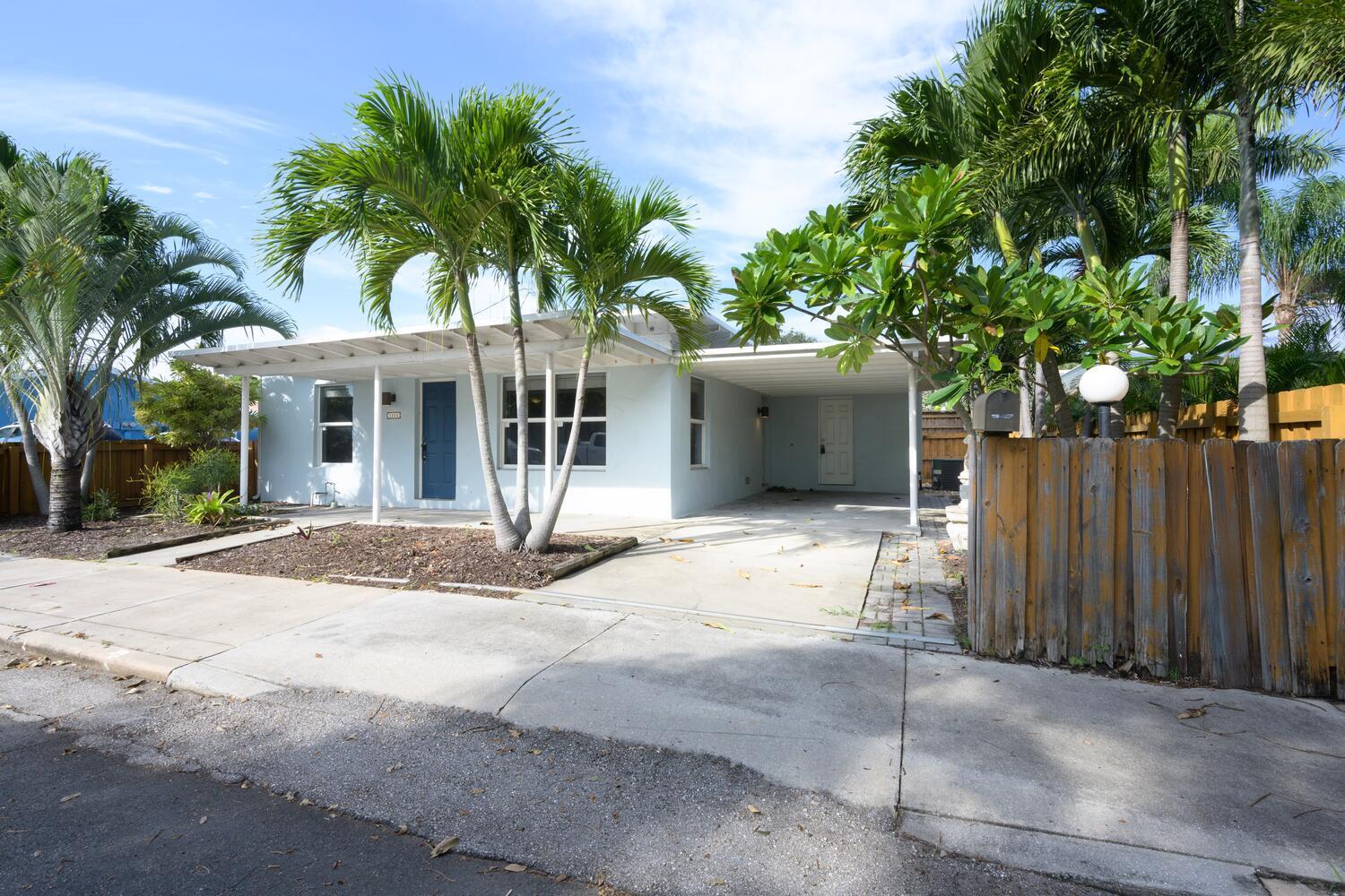 a view of a house with a yard and plant