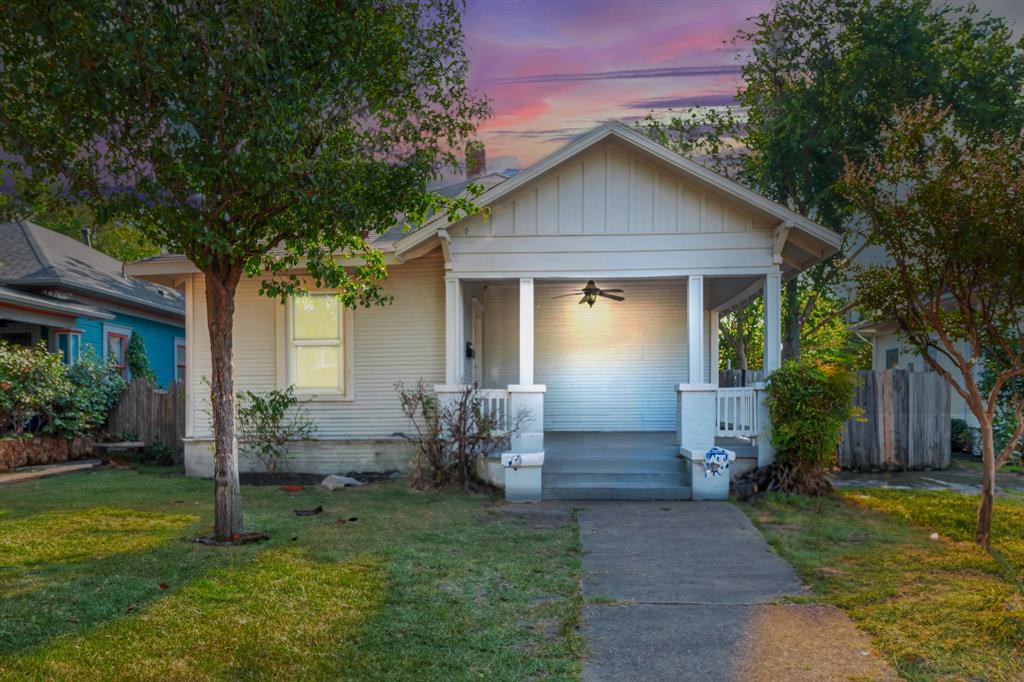 a front view of house with yard and outdoor seating