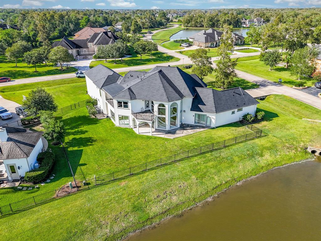 an aerial view of a house with a garden and lake view