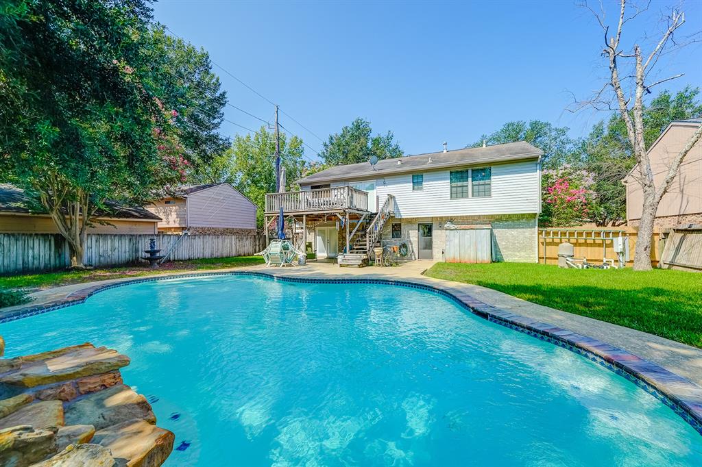 a view of house with swimming pool yard and outdoor seating