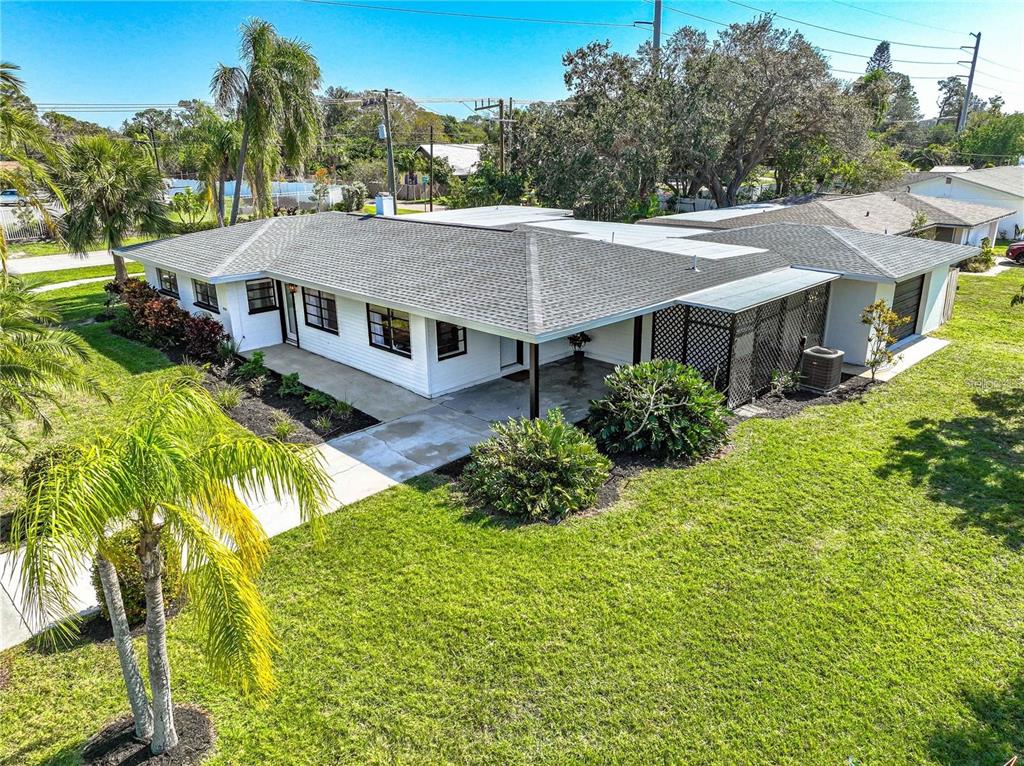 a aerial view of a house next to a big yard