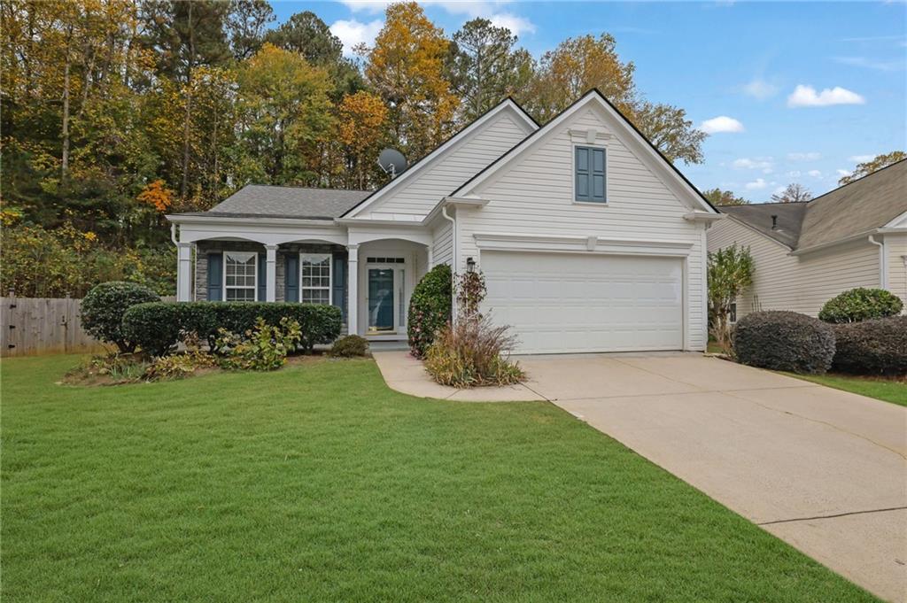 a front view of house with yard and green space