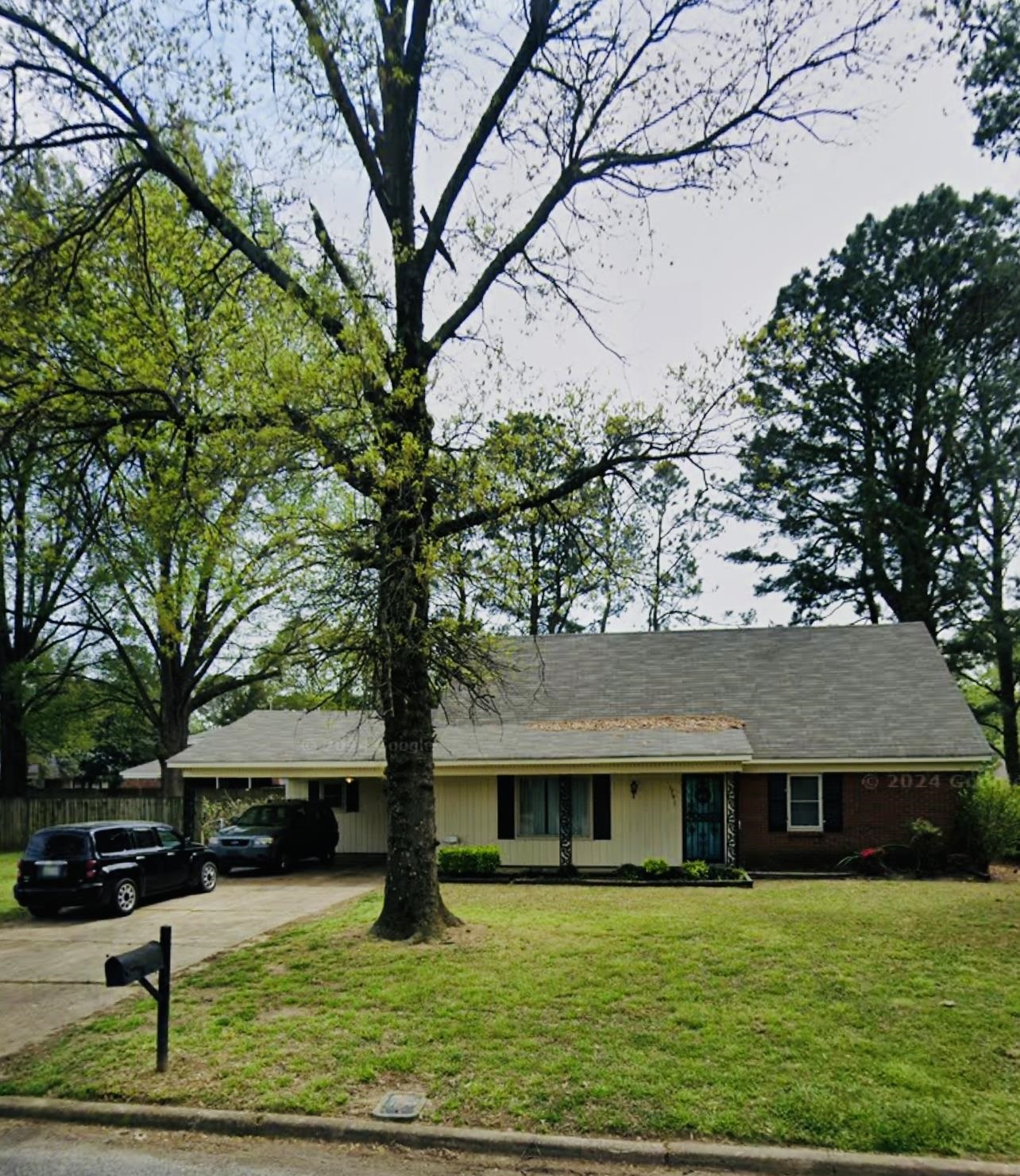 a view of house with yard