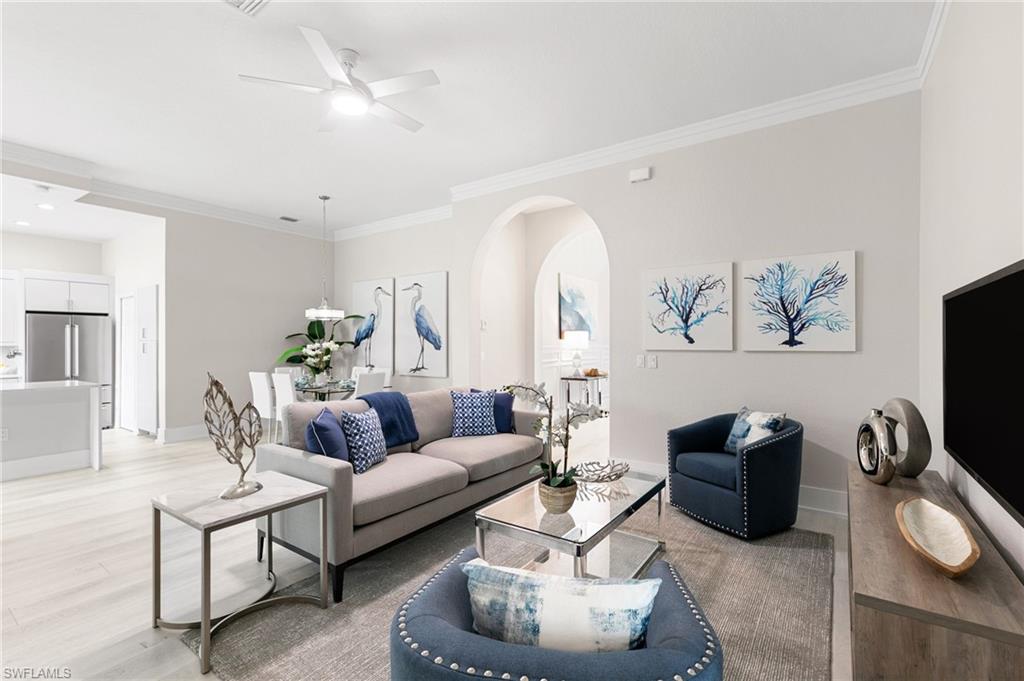 a living room with furniture a rug and a flat screen tv