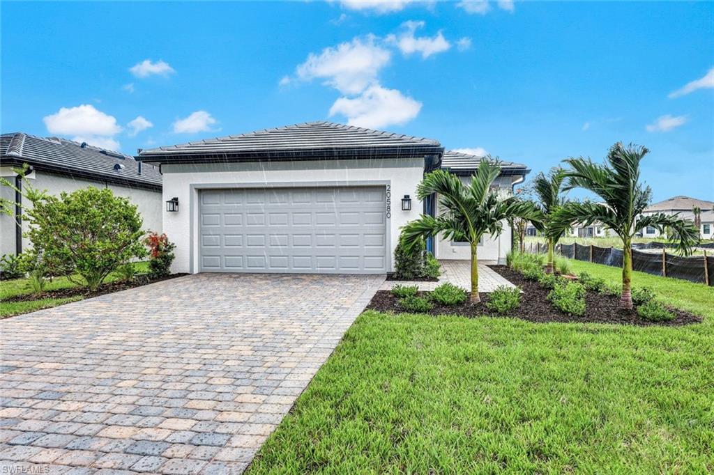 a front view of a house with a yard and garage