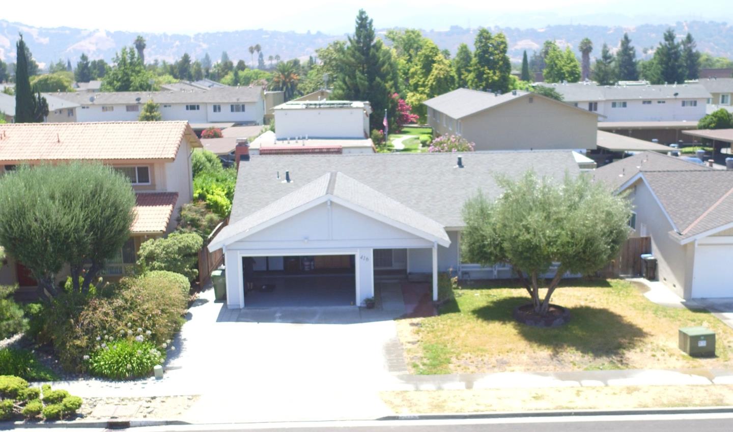 a view of house with outdoor space garden and tree