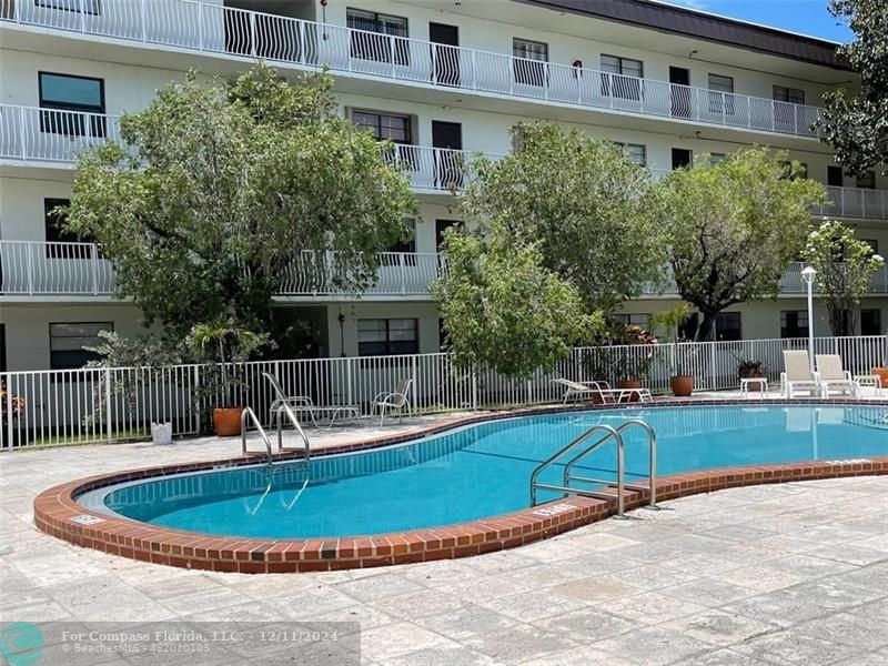 a view of a swimming pool with a patio