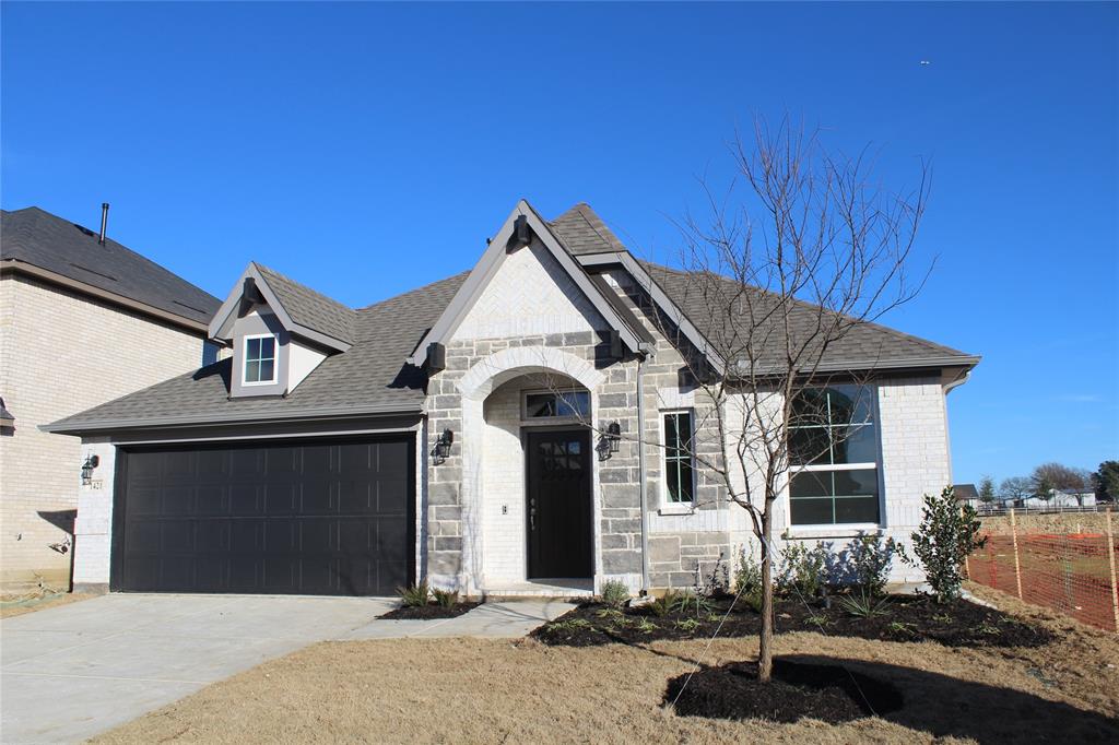 a front view of a house with garage