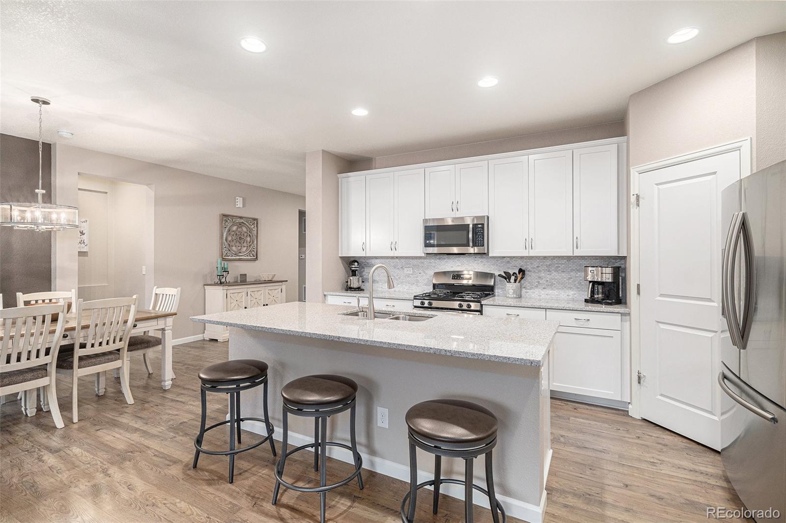 a kitchen with appliances a sink a counter top space and cabinets