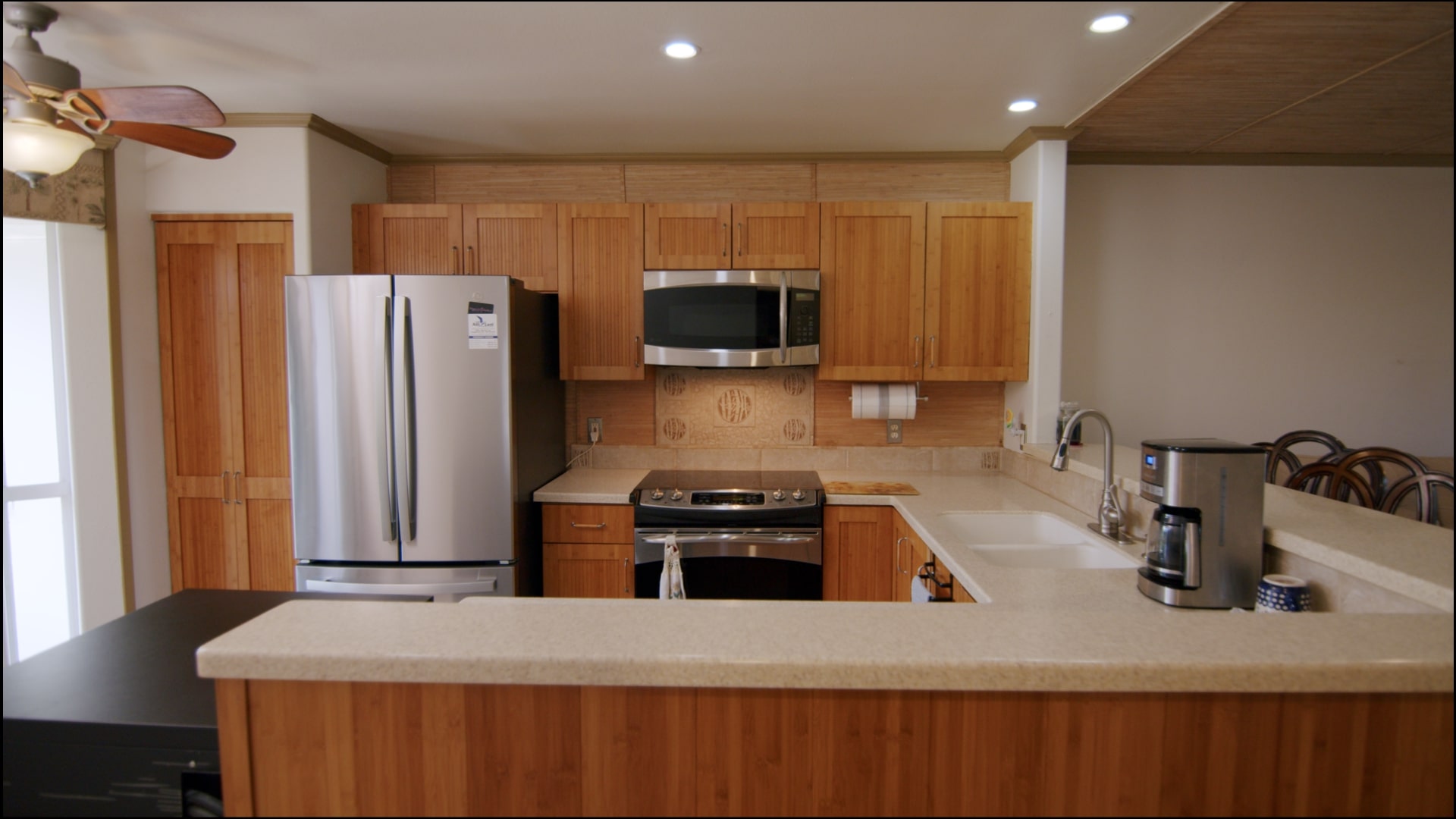 a kitchen with kitchen island a sink stainless steel appliances and cabinets