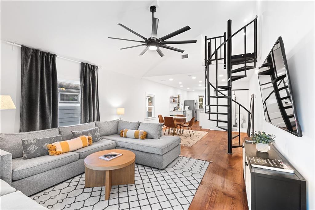 a living room with furniture and wooden floor