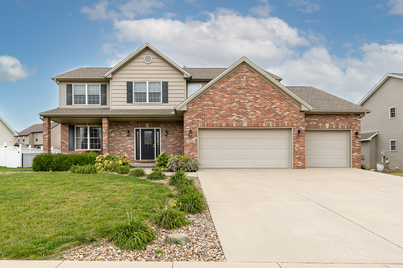 a front view of a house with a yard and garage