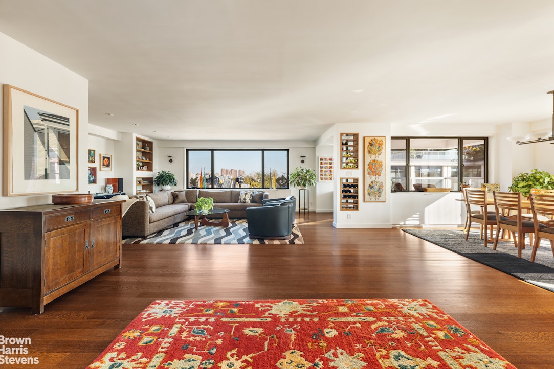 a living room with fireplace furniture and a wooden floor