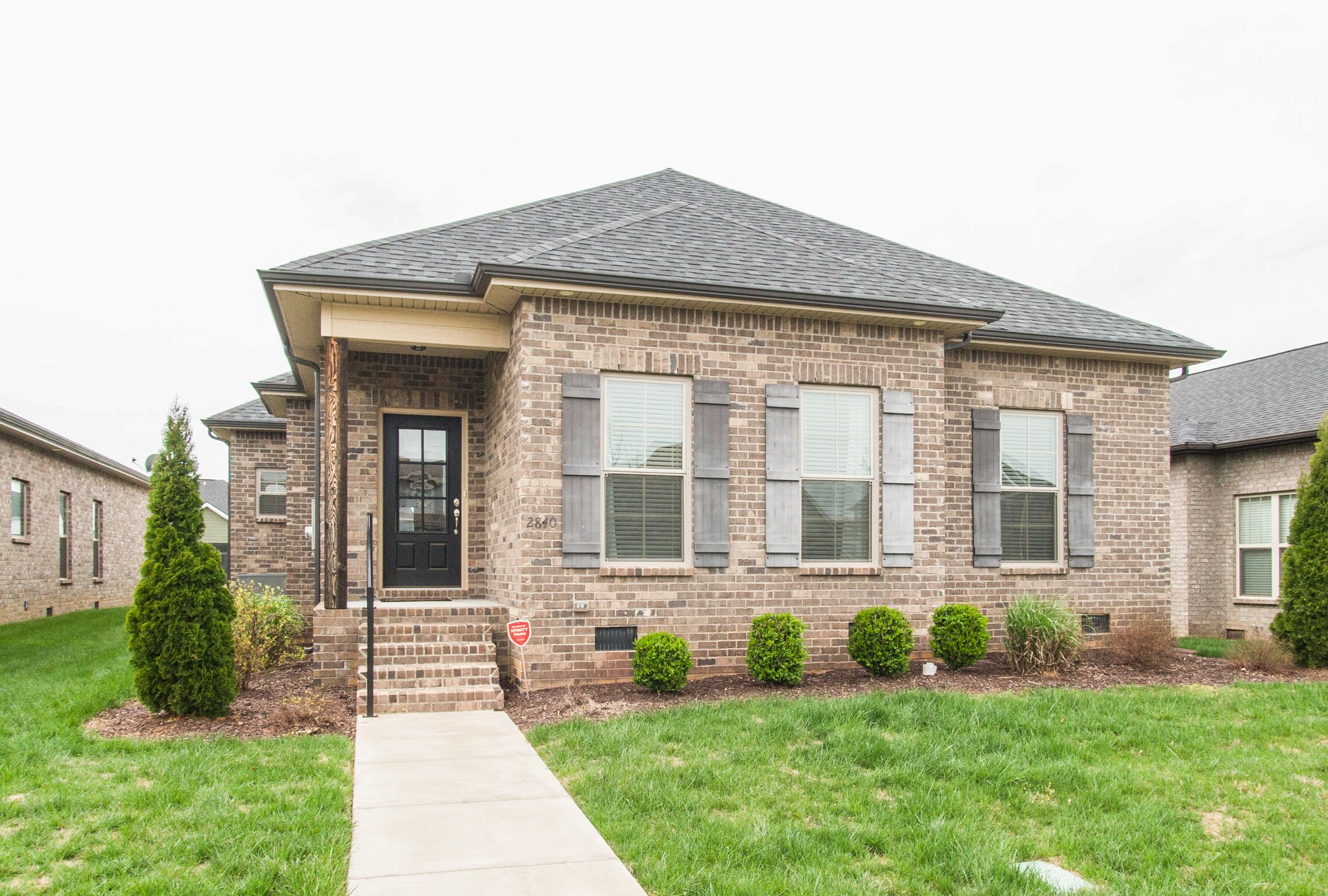 a front view of a house with a yard and outdoor seating