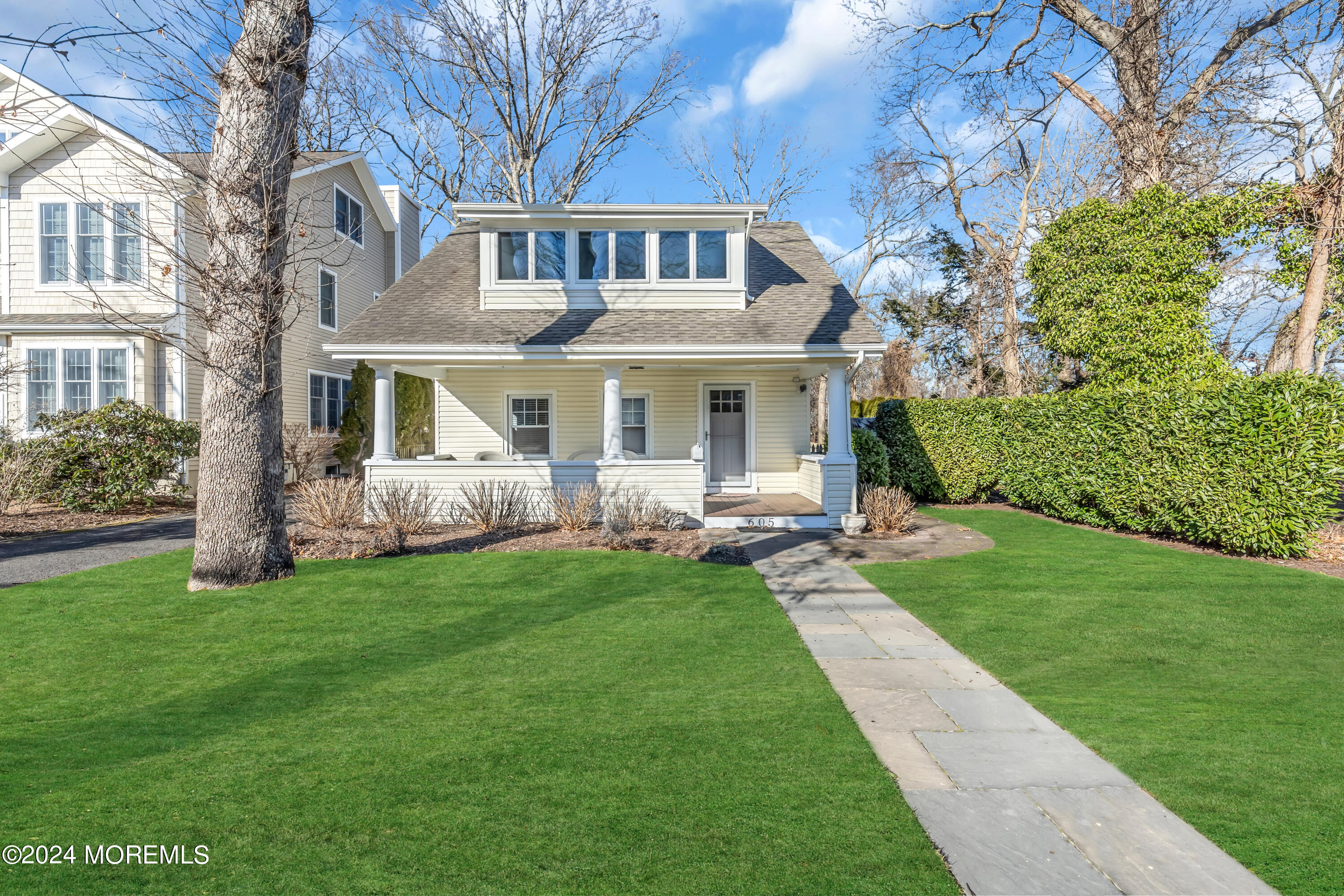 a front view of a house with a garden