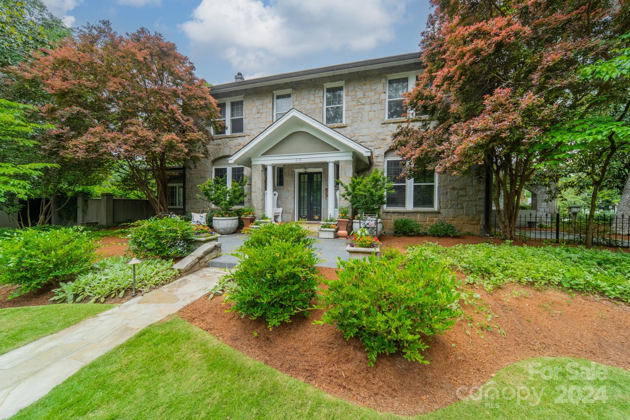 a front view of a house with garden