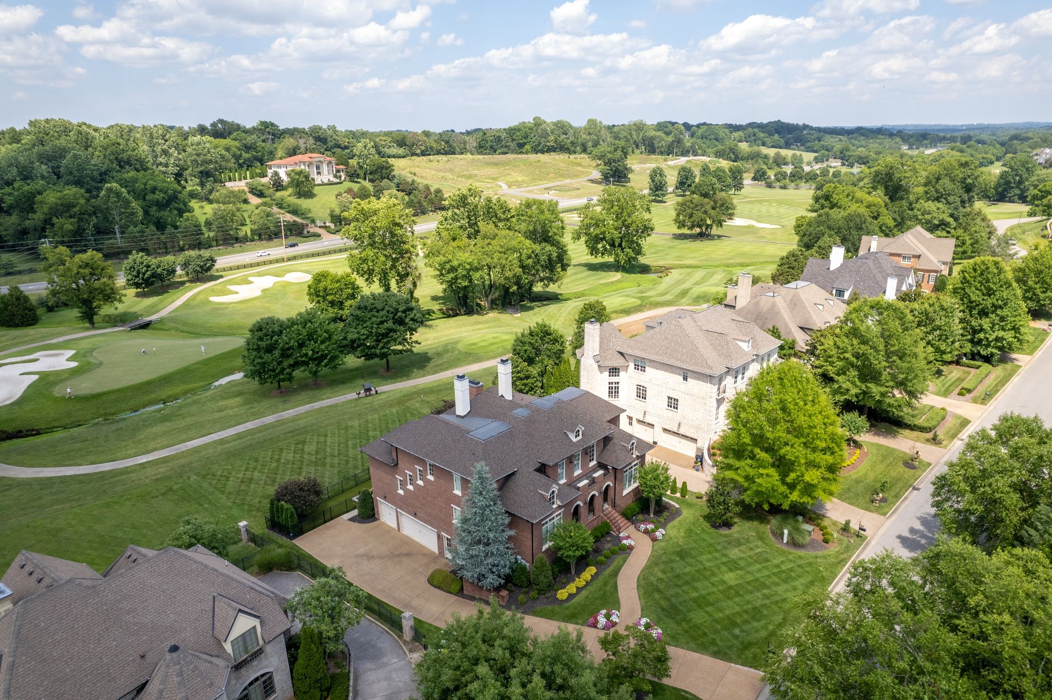 an aerial view of residential houses with outdoor space and street view