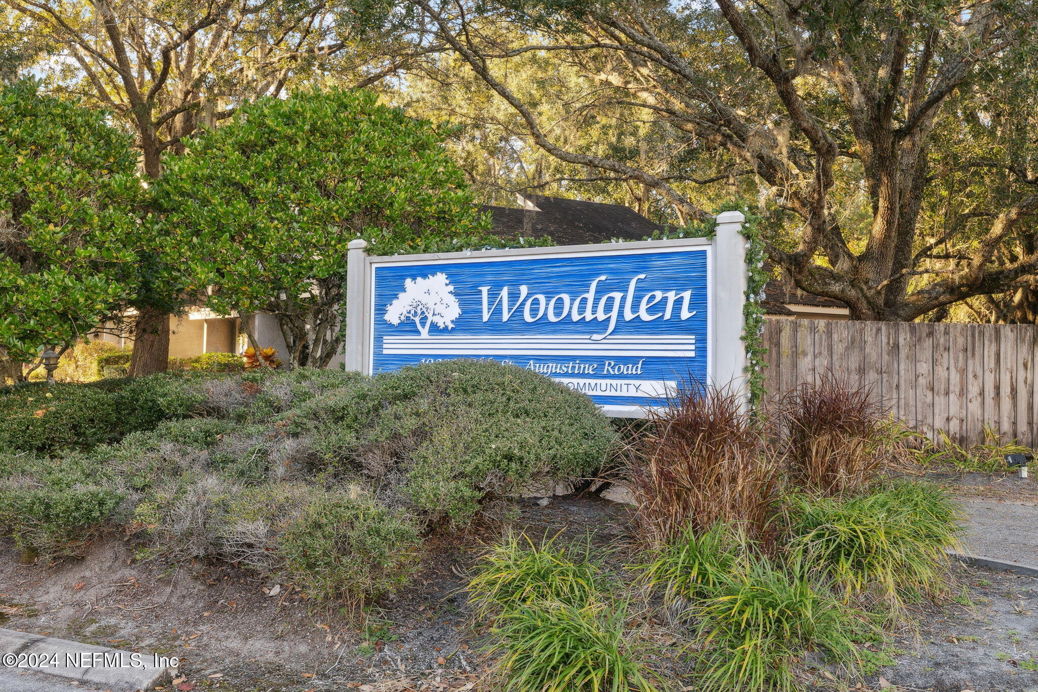 a sign broad in front of the red tree