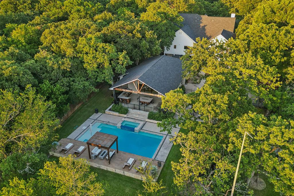 an aerial view of a house with swimming pool and garden view