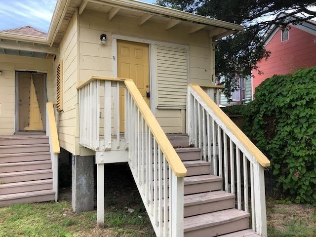 a view of a house with wooden stairs and a table