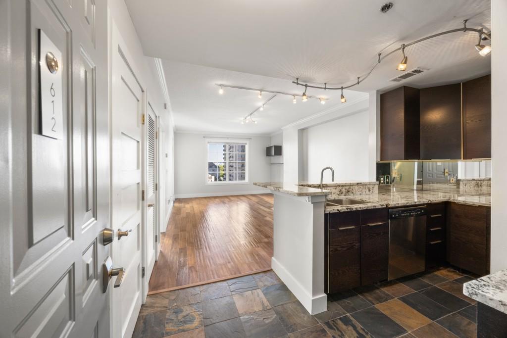 a spacious bathroom with a granite countertop sink a mirror and a bathtub