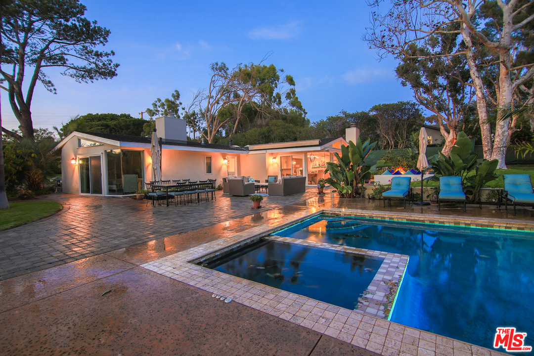 a view of swimming pool with outdoor seating