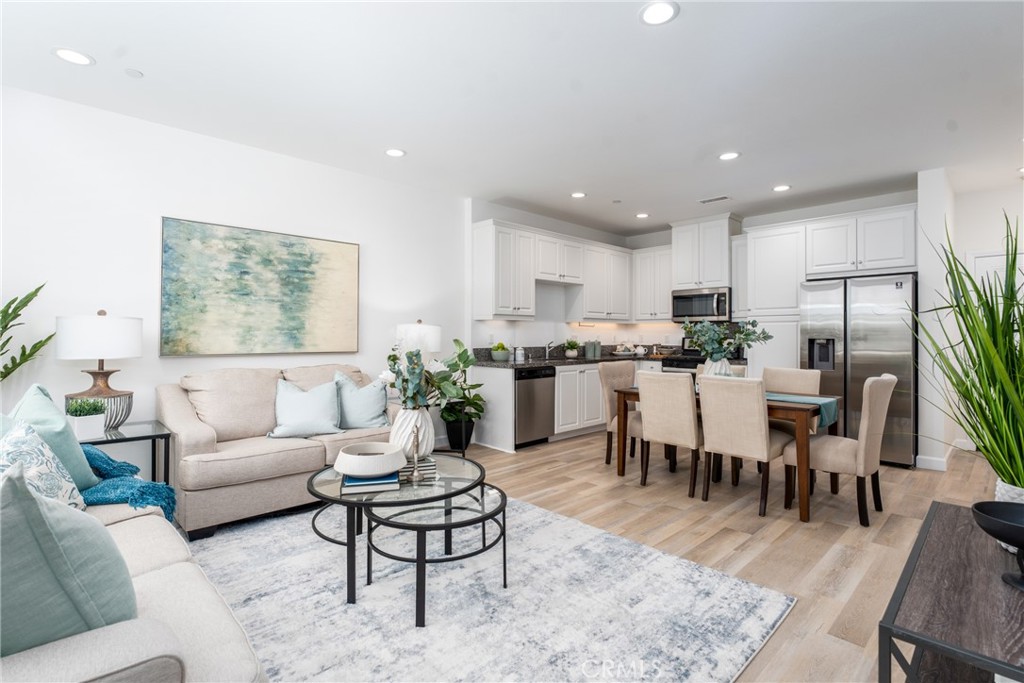 a living room with lots of furniture and kitchen view