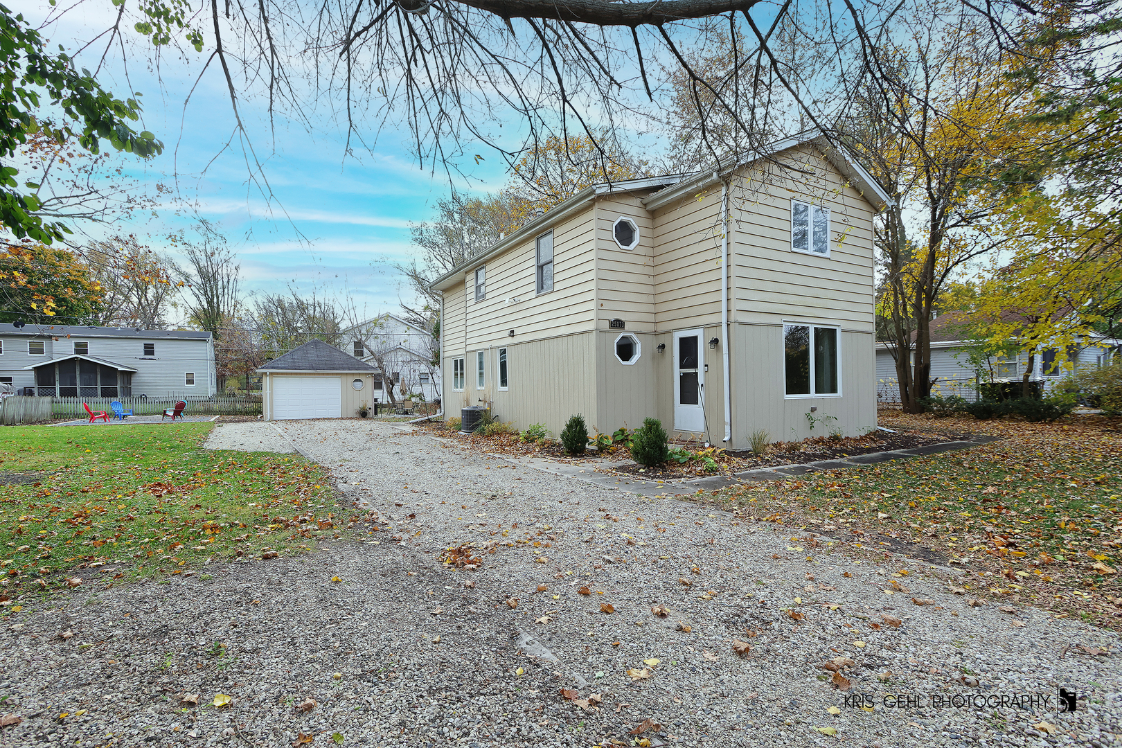 a view of a yard with a house and a tree