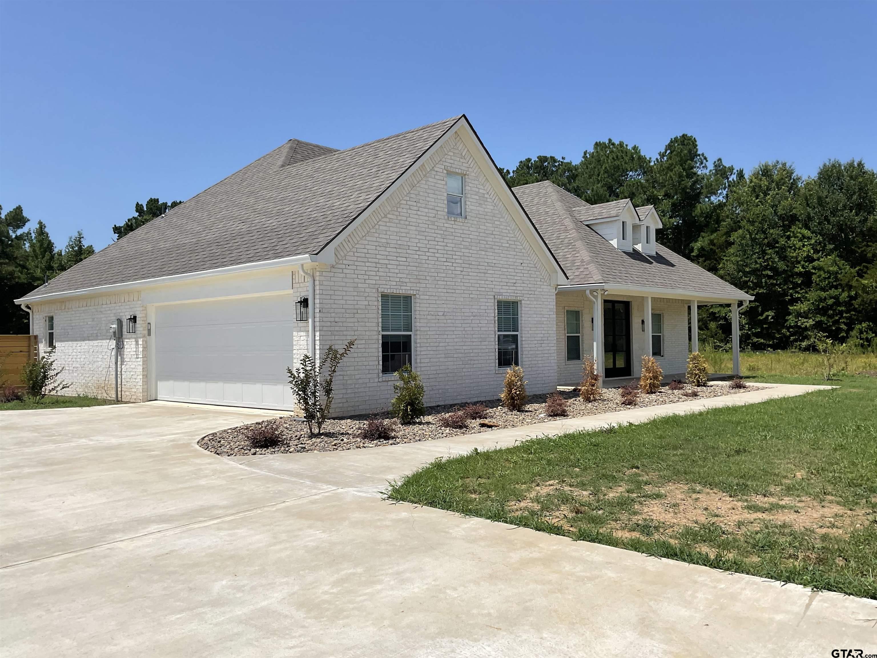 a front view of a house with a yard and porch