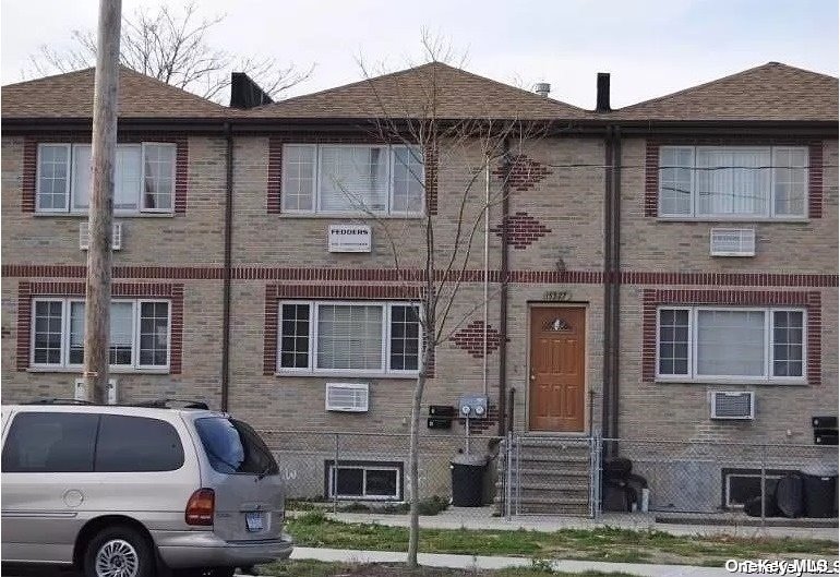 a front view of a house with parking space